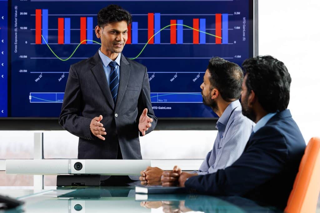 Executive presenting data to colleagues in a modern boardroom, Chicago Business Photography capturing leadership in action.