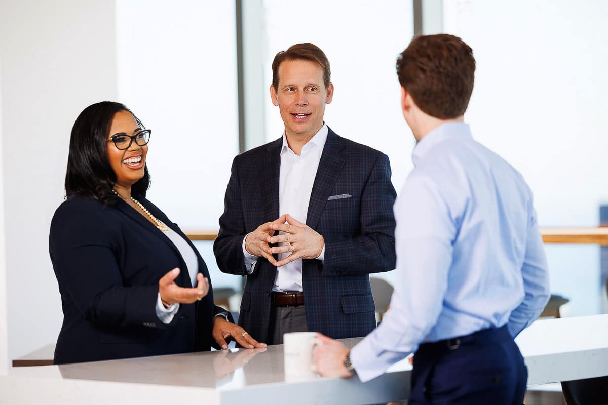 Corporate lifestyle photography of professionals engaged in conversation during an in-office discussion