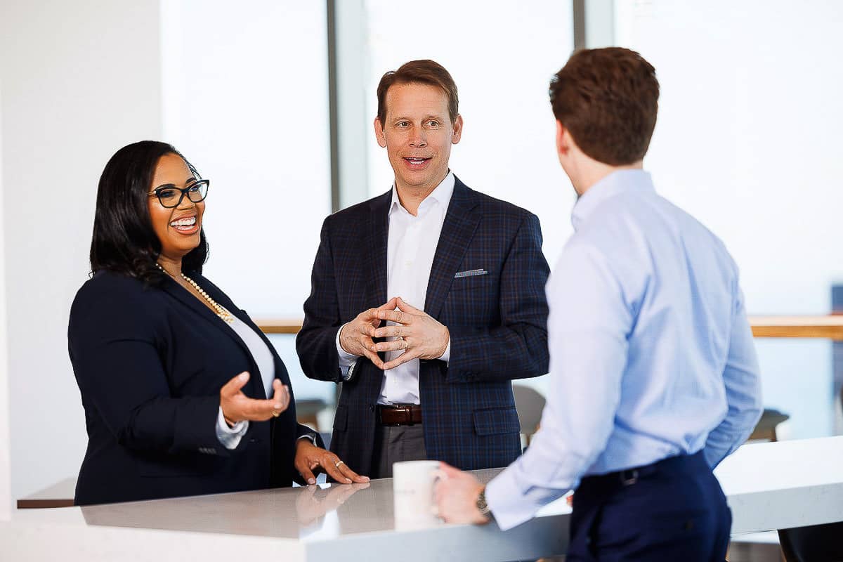 Corporate professionals engaged in a strategic discussion inside a contemporary office.