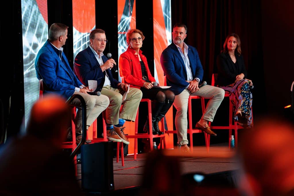 Panel of speakers on stage during a business conference — Chicago corporate event photography