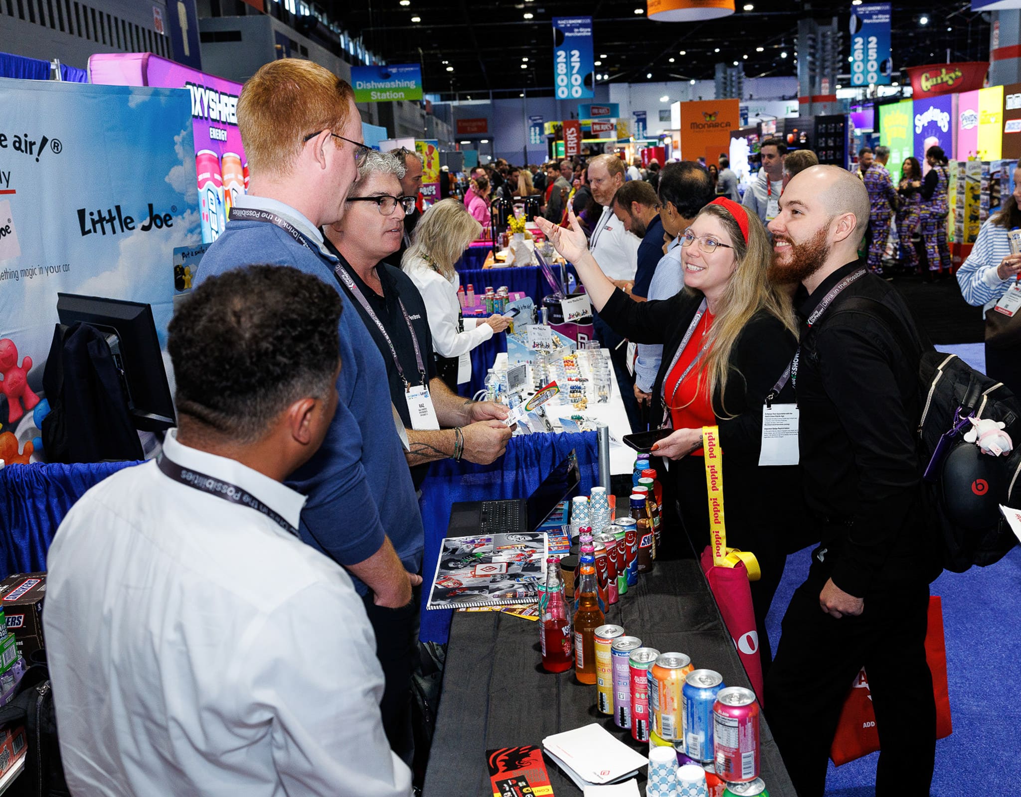 Chicago corporate event photographer captures attendees networking at a trade show booth