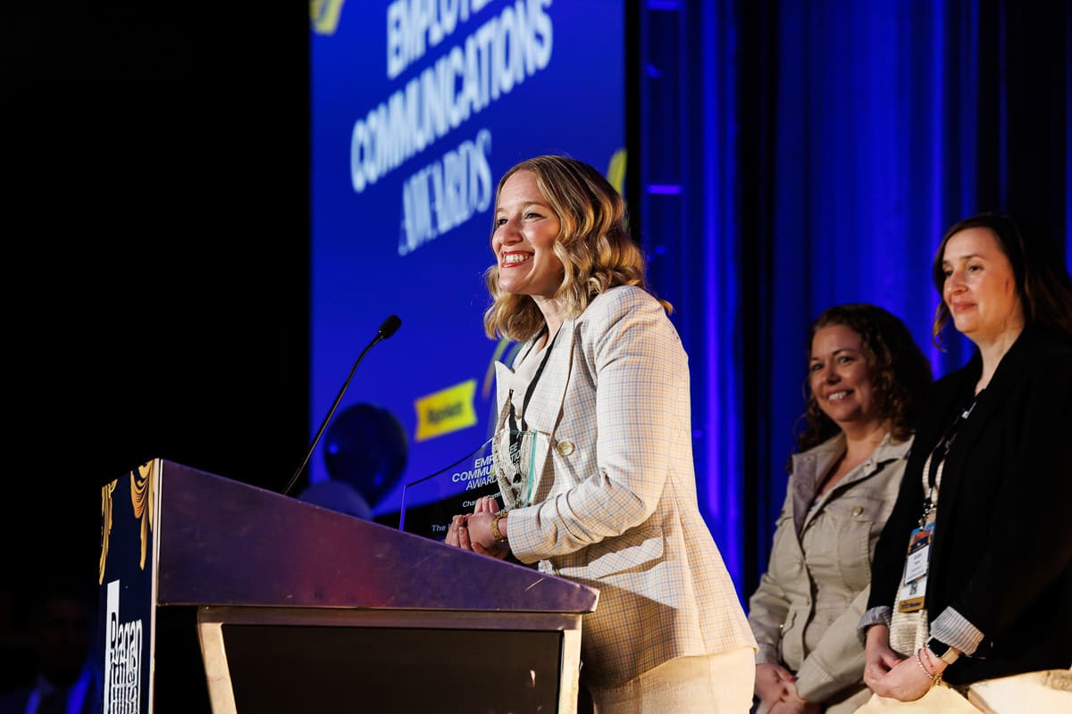 Chicago corporate event photography capturing speakers at an award podium during a corporate conference