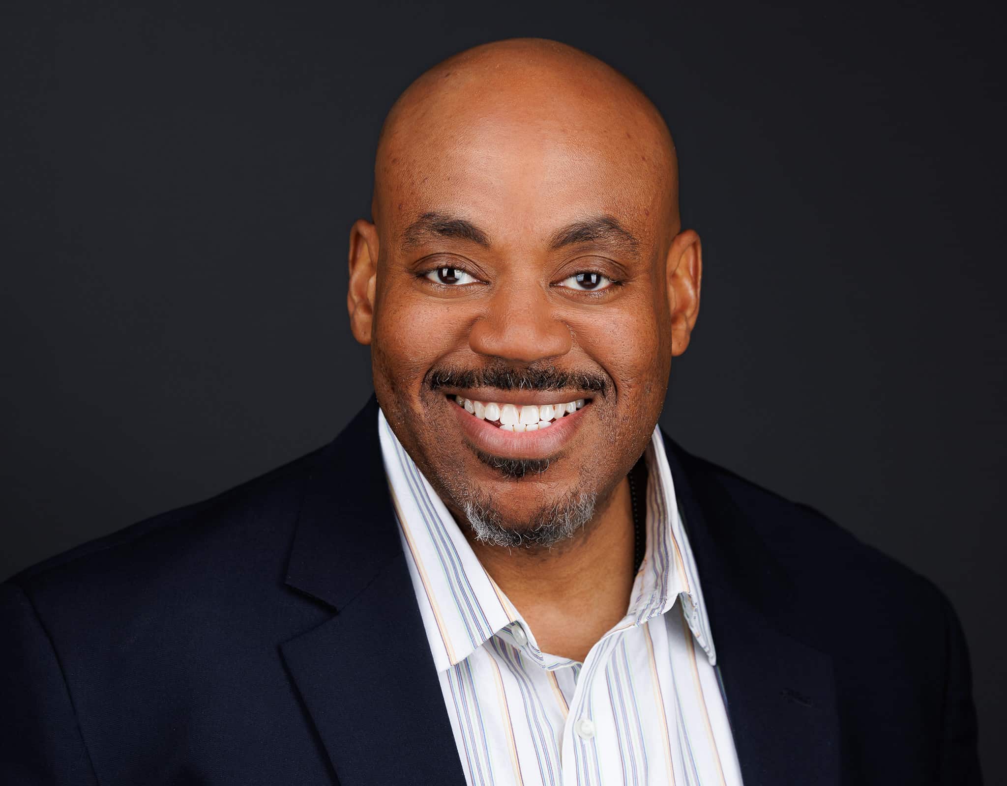 Professional woman in gray blazer photographed in studio for Chicago corporate headshots