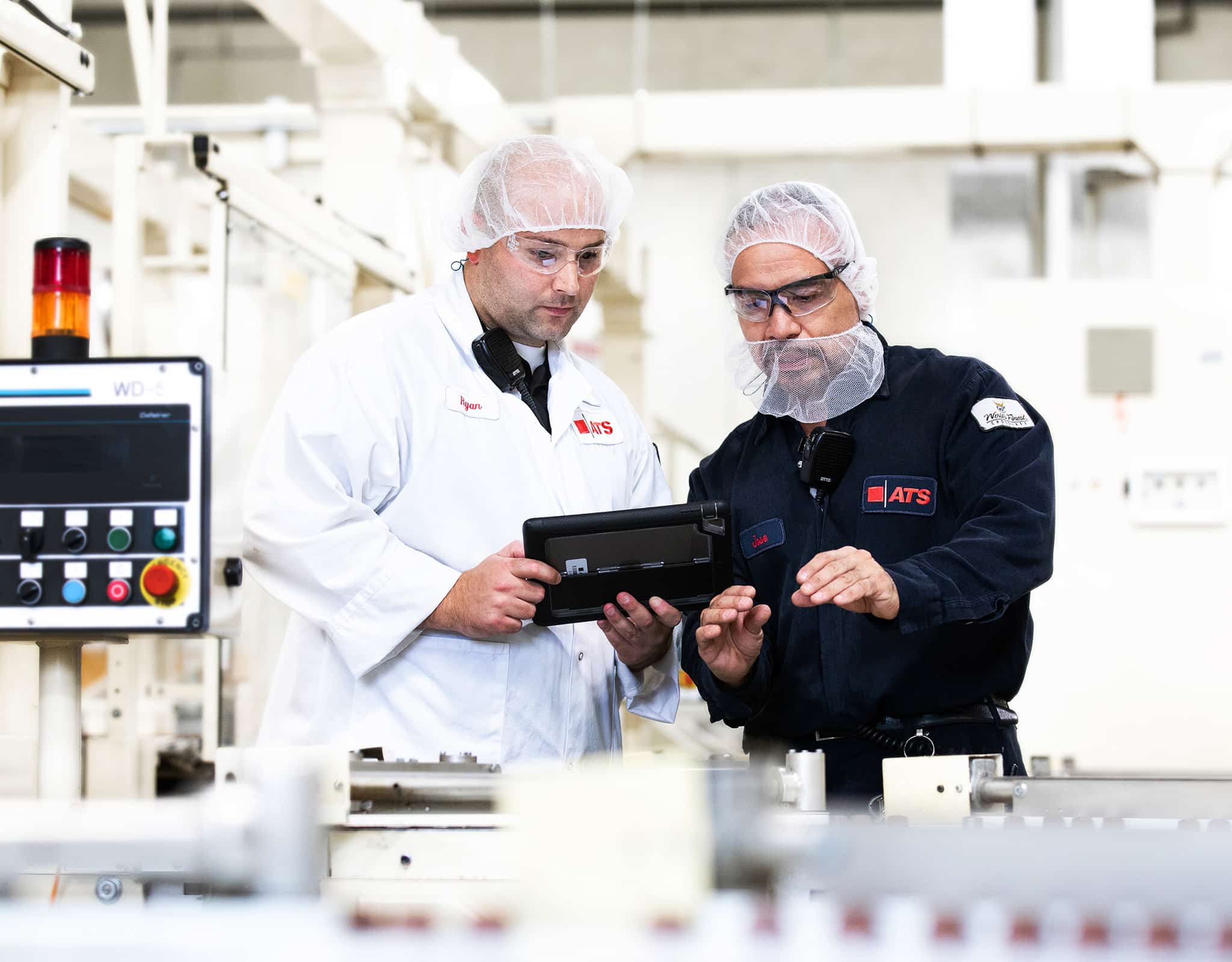 Chicago corporate lifestyle photography of an industrial team reviewing production data on a tablet.