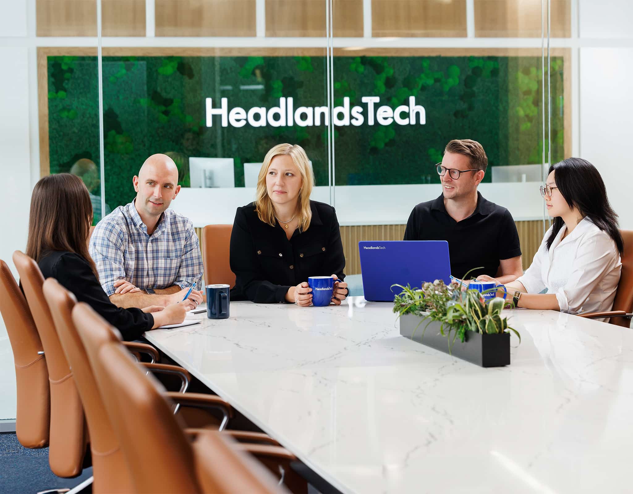 Chicago corporate lifestyle photography capturing a leadership team meeting in a modern conference room.