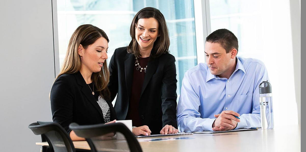 Chicago corporate lifestyle photography of a team meeting and reviewing documents in a conference room
