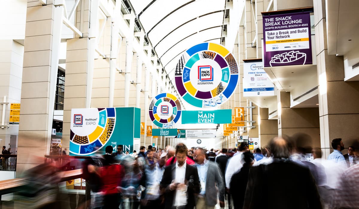 Attendees entering a bustling trade show at a convention center, photographed by Chicago corporate photographer Tori Soper.