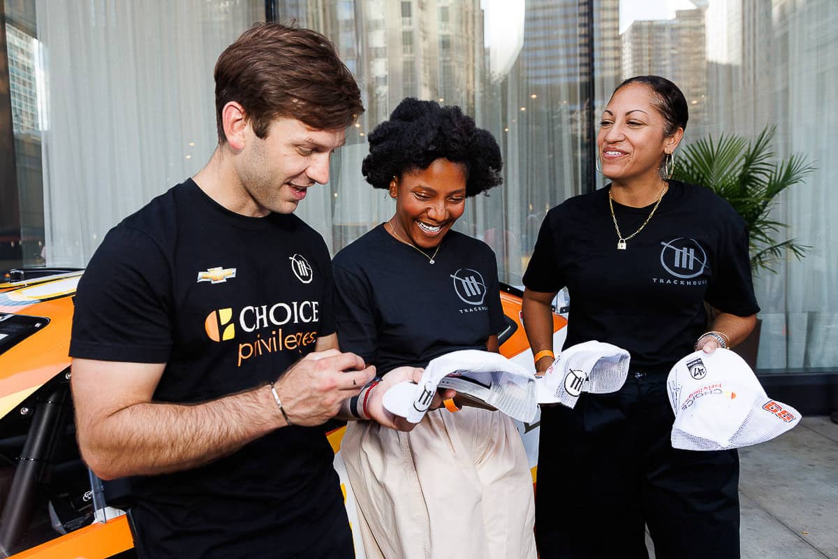 Team members engaging with attendees at a branded product activation in Chicago, photographed by Chicago corporate event photographer Tori Soper.