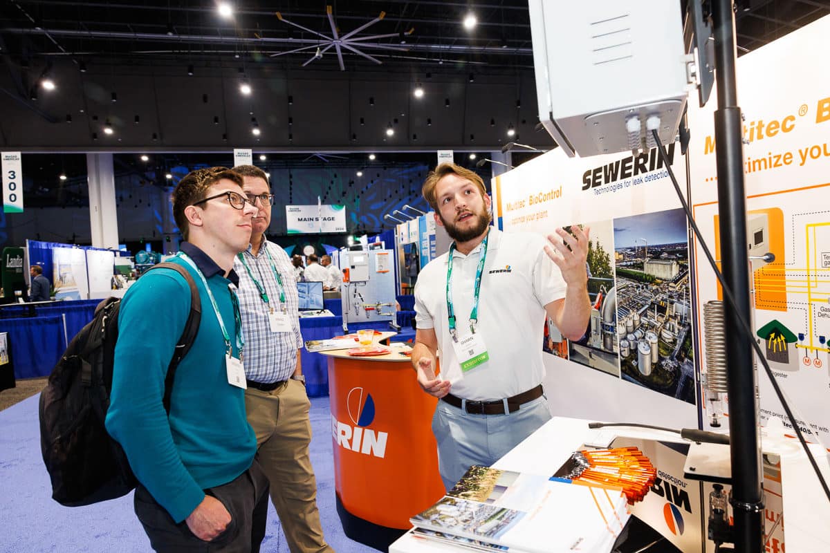 Chicago corporate event photographer documents trade show booth interaction at industry event