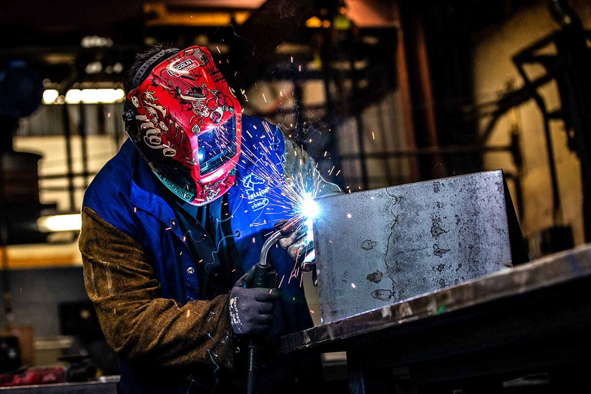 Industrial welder working on a Corporate lifestyle photography of a welder working in an industrial facilitymetal project, captured for Chicago business photography to showcase manufacturing capabilities and craftsmanship.
