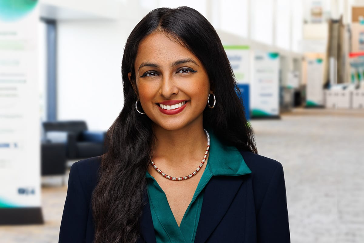 Confident woman in a green blouse and blazer, environmental Chicago corporate headshot on location.