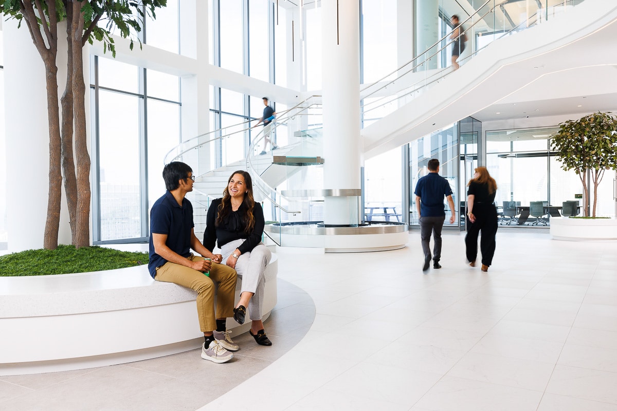 Corporate lifestyle photography of employees moving through a modern corporate lobby and common area