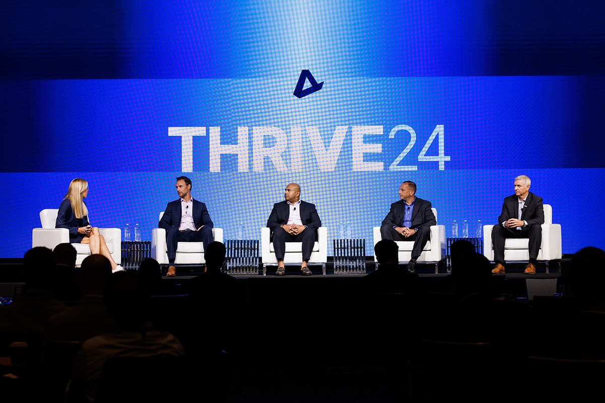 Panel discussion with speakers on stage at a Chicago corporate conference, photographed by Chicago corporate event photographer Tori Soper.