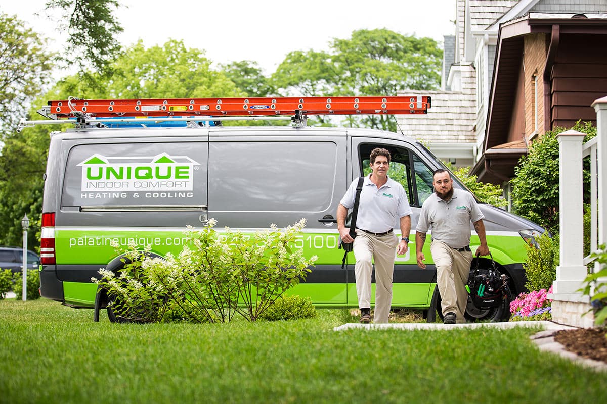 Corporate lifestyle photography of service technicians standing outside a branded company vehicle